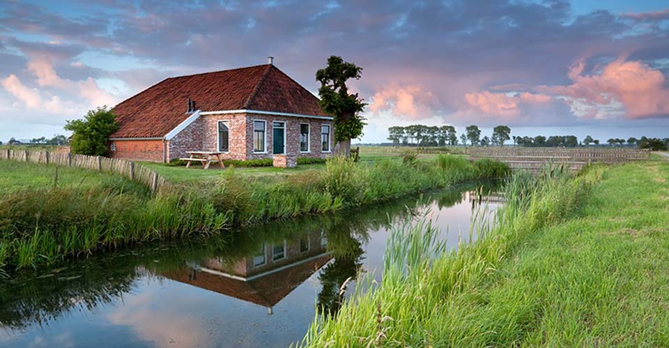 beautiful cozy farmland by river at sunset